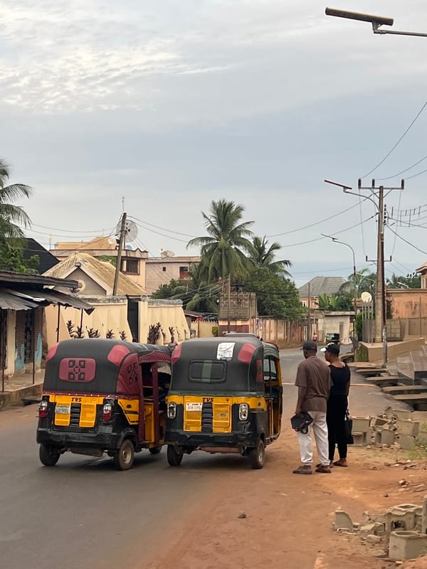 Open-air cooking and street activity in Nkpor, Nigeria