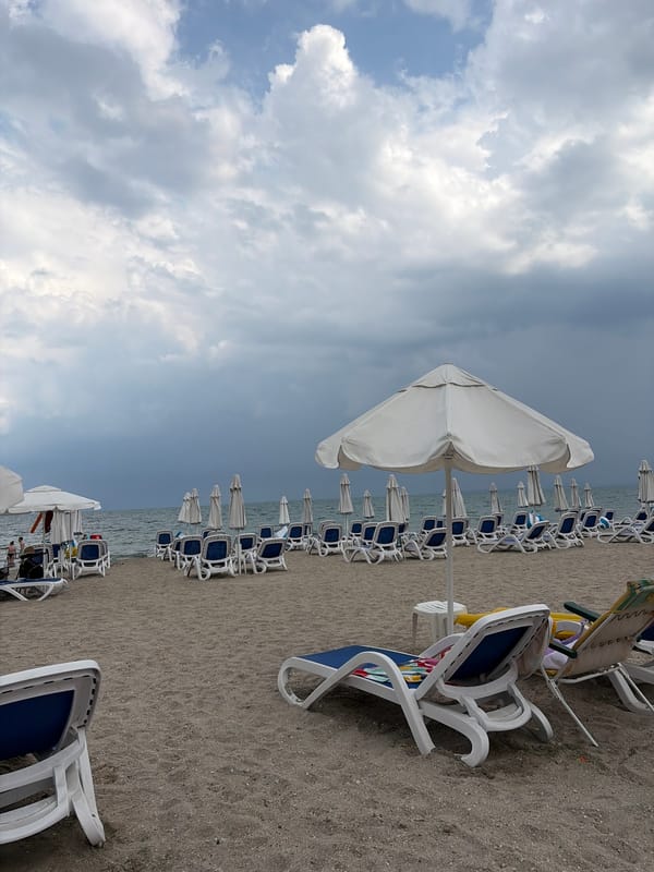 Empty lounge chairs on a cloudy Pomorie beach