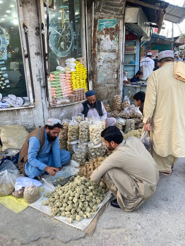 Vendor sells dry fruits and candies at Quetta market