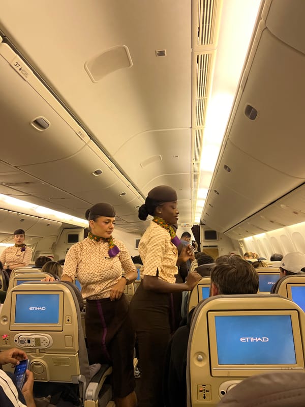 Etihad cabin scenes, Bali — boarding, in-flight, and crew