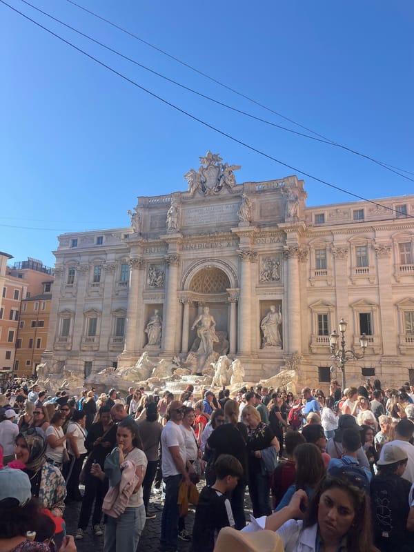 Daytime crowds gather at Rome's historic Trevi Fountain