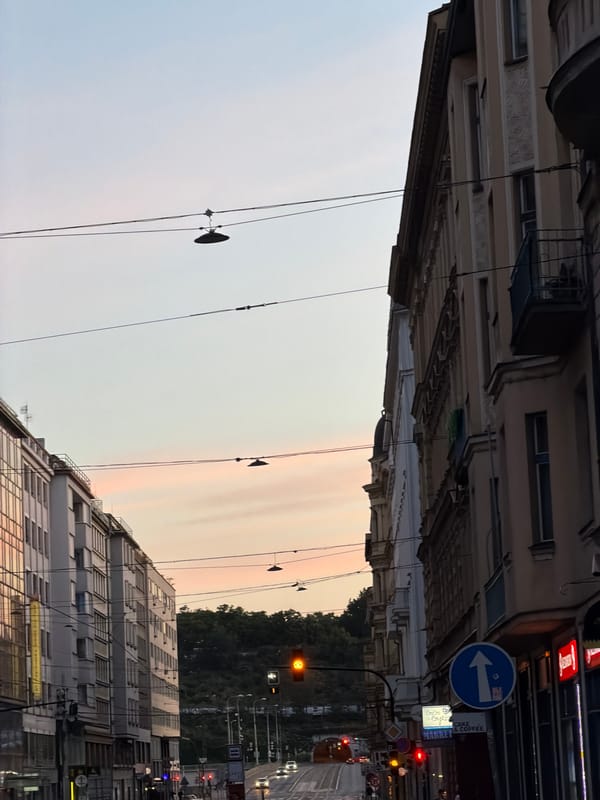 Prague streets at golden hour, moon still hanging in the sky