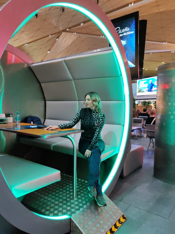 Woman documented in modern seating areas at Saint Petersburg airport