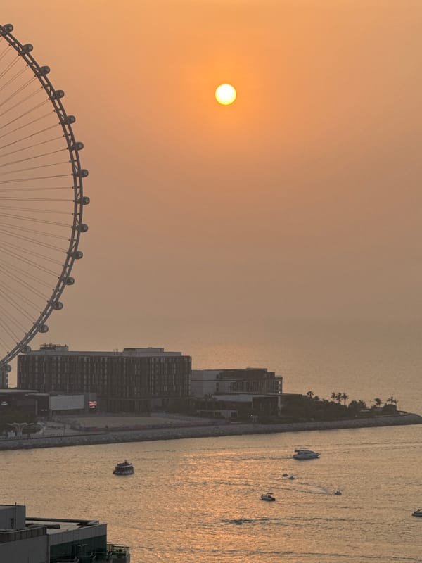 Hazy Gulf sunset with Ain Dubai from a Dubai high-rise