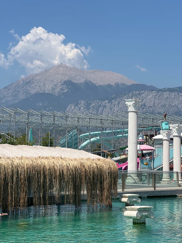 Water park in Kemer with mountain views and poolside statues
