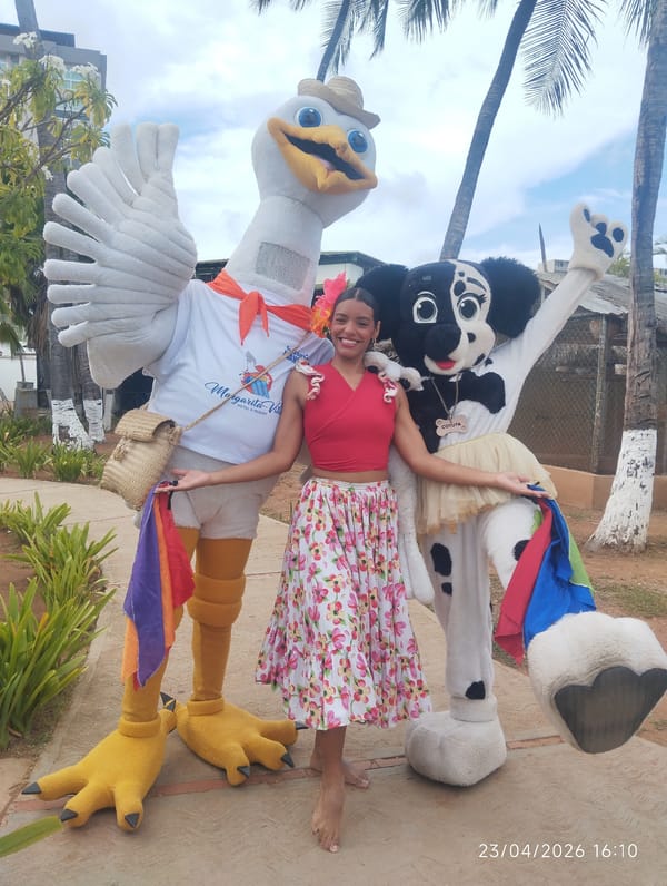 Woman poses with mascots in tropical outdoor setting