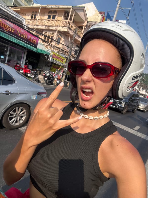 Scooter riders capture selfie moment in sunny Patong Thailand