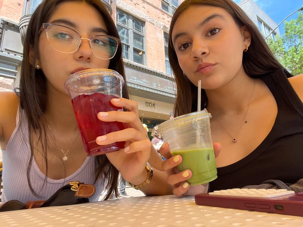 Two women enjoy colorful beverages at Austin cafe