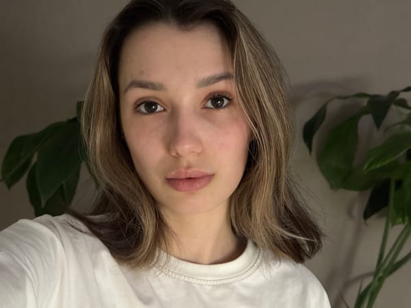 Young woman captures multiple selfie portraits indoors Tuesday afternoon