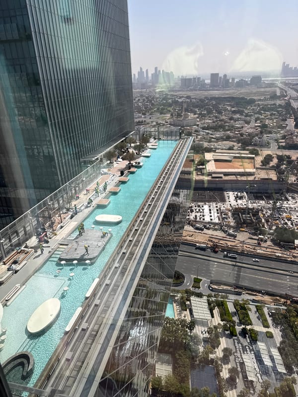Dubai skyscraper rooftop pool complex observed from aerial view