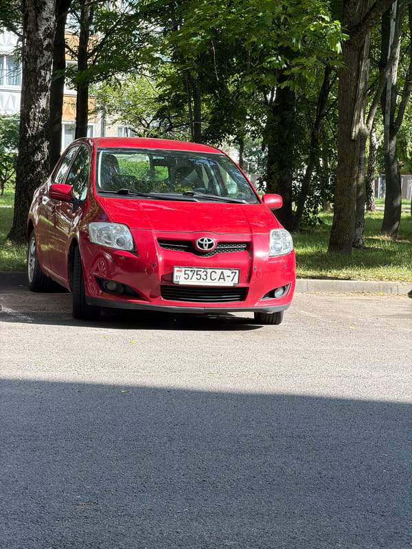Three parked cars outside a Minsk apartment block