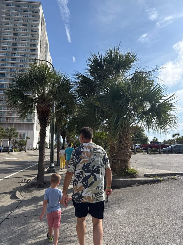Sunny afternoon stroll along a palm-lined Myrtle Beach hotel strip