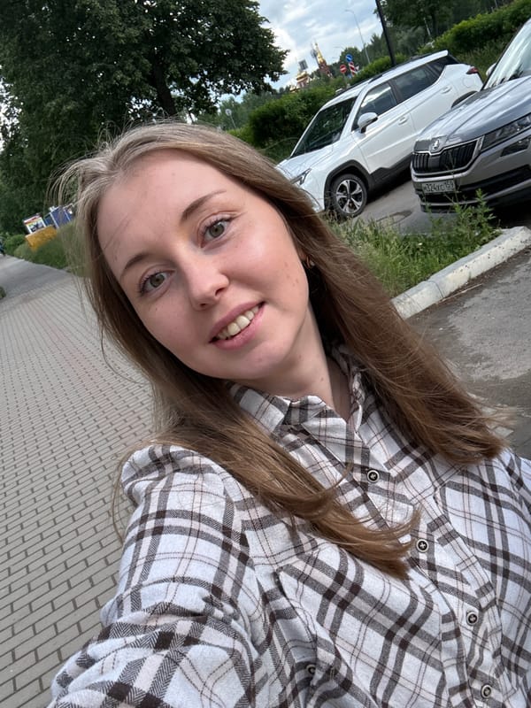 Woman takes outdoor selfies during cloudy afternoon photo session