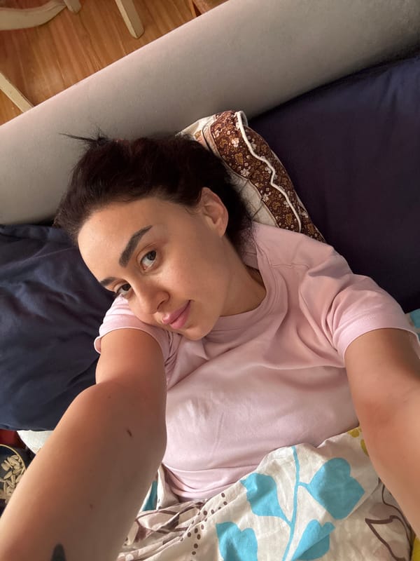 Morning documentation in Tbilisi bedroom features selfie, decorative dreamcatcher