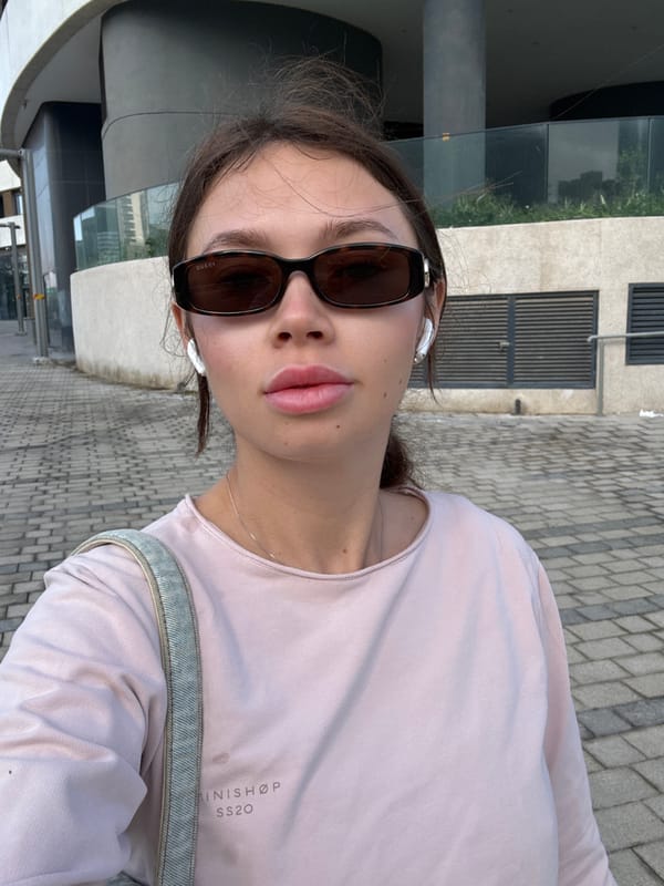 Woman takes morning selfies in designer wear in Tel Aviv