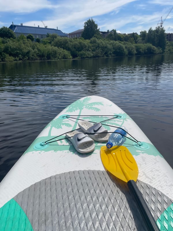 Paddleboarders enjoy sunny morning on Vologda River, Russia