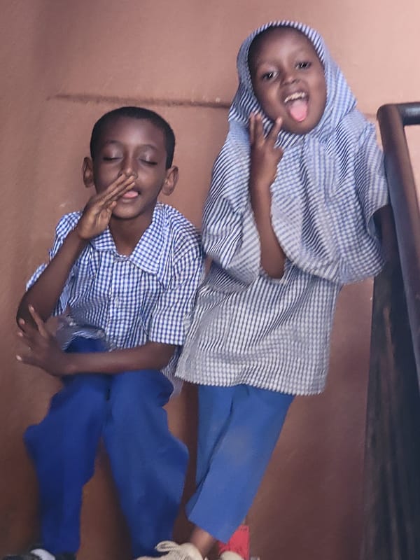 Children and adult photographed in casual gathering, Maiburiji Nigeria