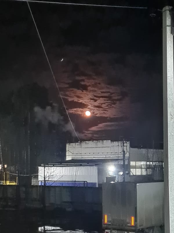 Man smoking outdoors at night in Noviy, Russia