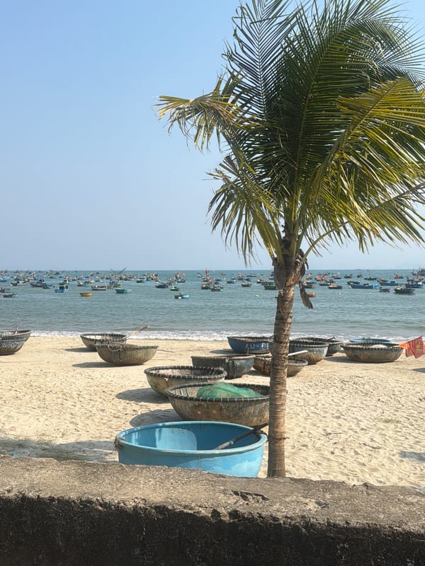 Traditional fishing boats rest on Đà Nẵng beach