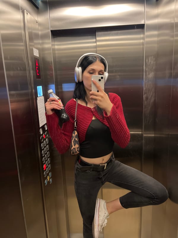 Elevator selfie with red sweater and headphones