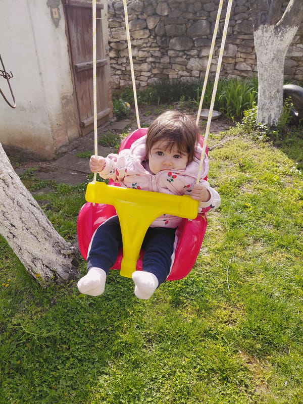 Child plays on swing set in Samovodene, Bulgaria