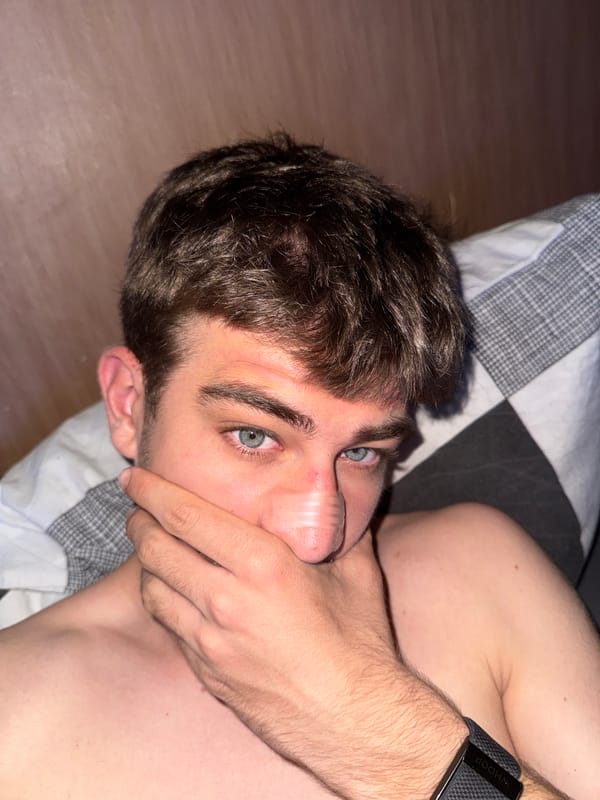 Young man rests on bed with bandage in Sofia