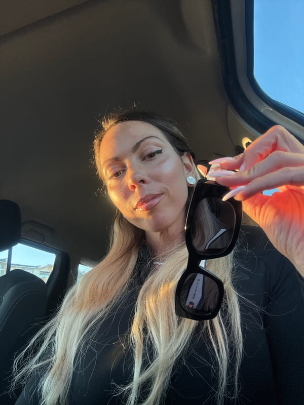 Woman photographed with sunglasses inside car in Ravda, Bulgaria