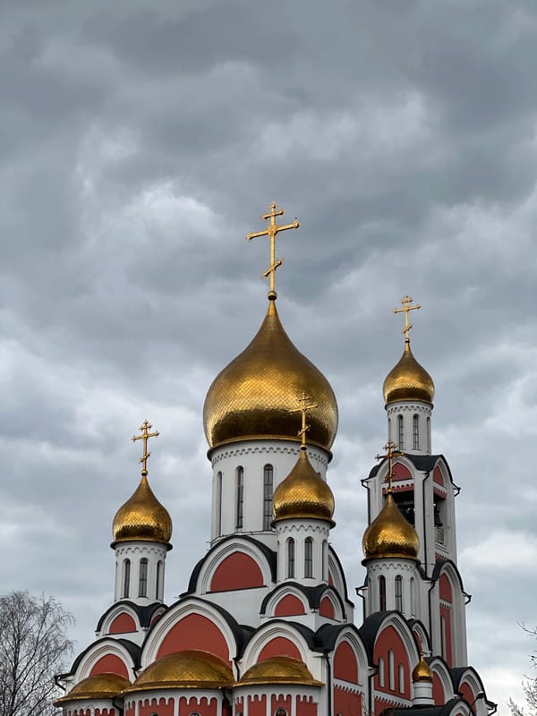 Tourist visits Orthodox church in Odintsovo under cloudy skies