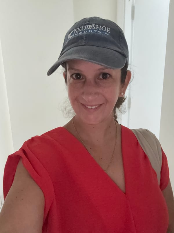 Woman in baseball cap photographed smiling in Ancón, Peru