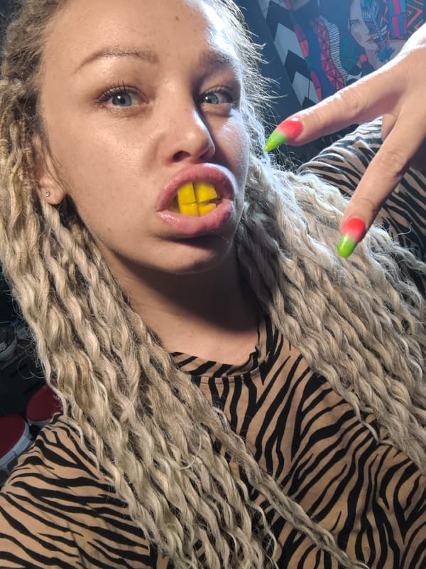 Woman poses with candy in zebra-striped shirt, Noviy