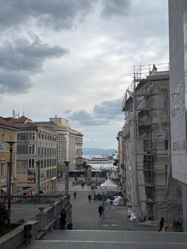 Pedestrians captured on Rijeka city streets during cloudy afternoon