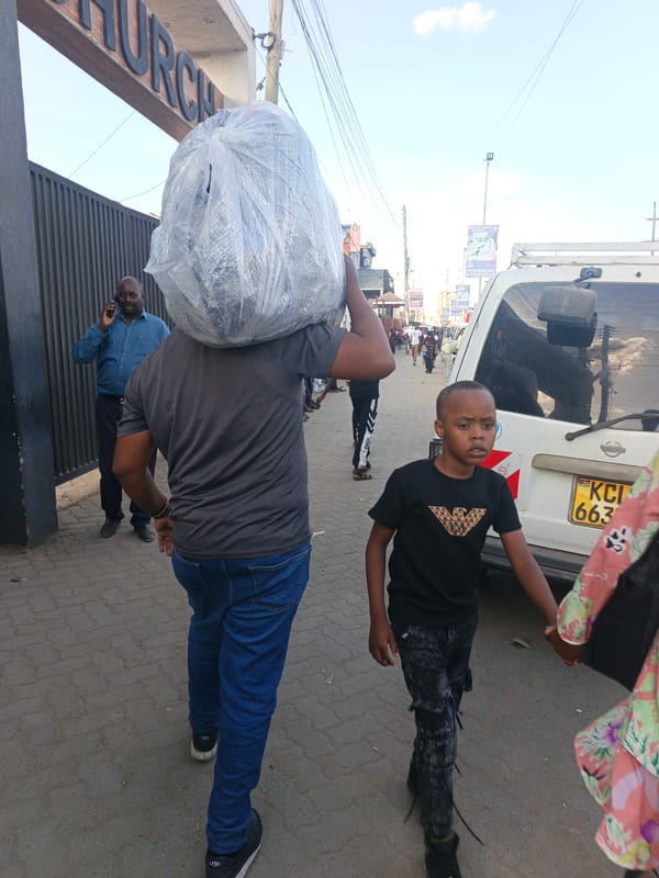 Men carrying bundles observed on Nairobi street