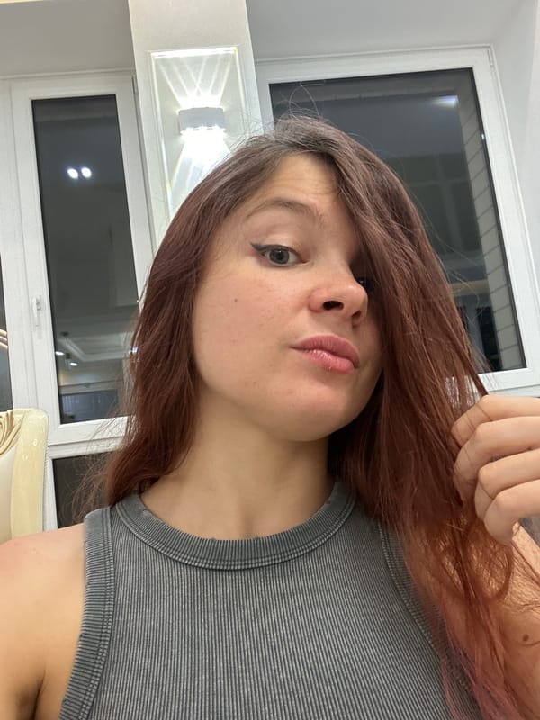 Woman in striped tank top observed indoors in Vladimir