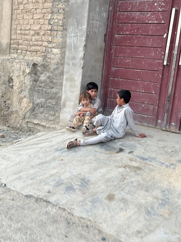 Street scenes from Quetta: a doorway moment and a motorcycle ride