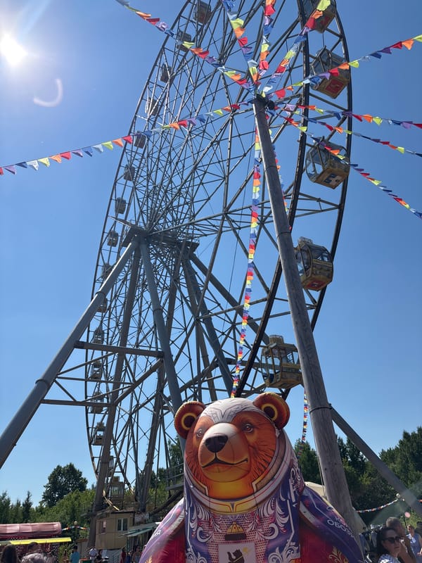 Ferris wheel operates with decorative flags in Rusanovo, Russia