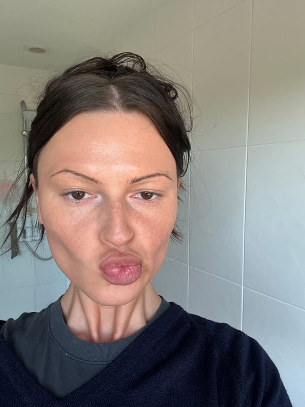 Woman photographed making blowing gesture in Wealden, UK