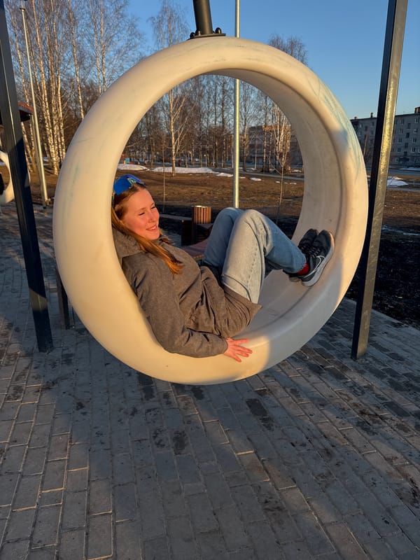 Woman enjoys afternoon at Berezniki playground near cathedral