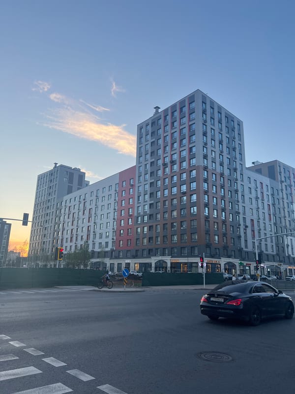 Late afternoon street life across modern Astana neighborhoods