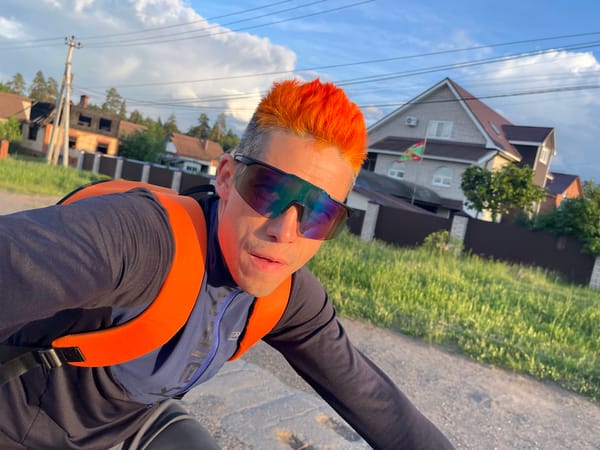 Cyclist travels concrete road at sunset in Chaikovsky, Russia