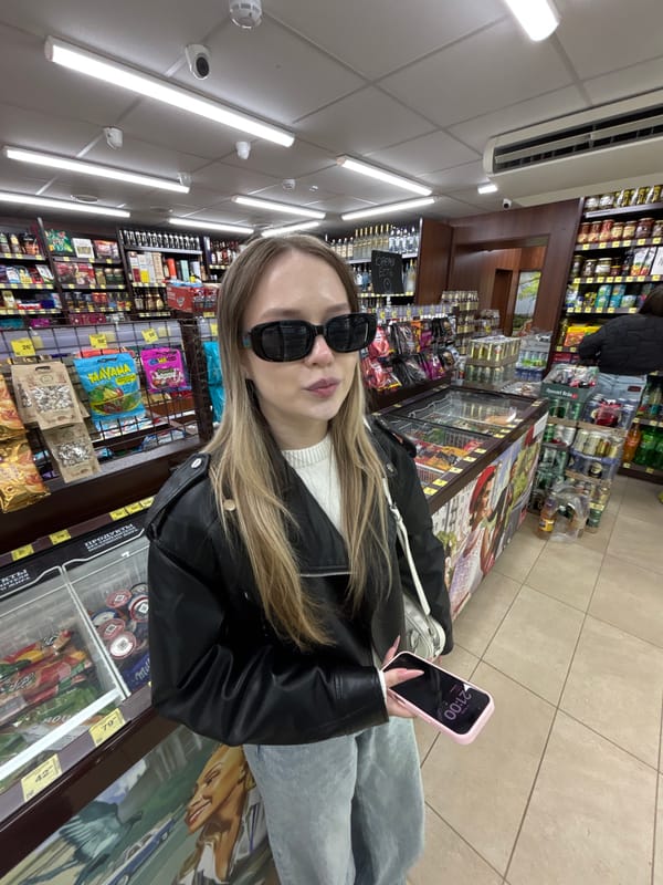 Young women pose for photos in Фоки convenience store