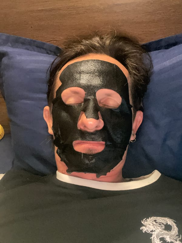 Person in face mask rests on pillow in Mumbai