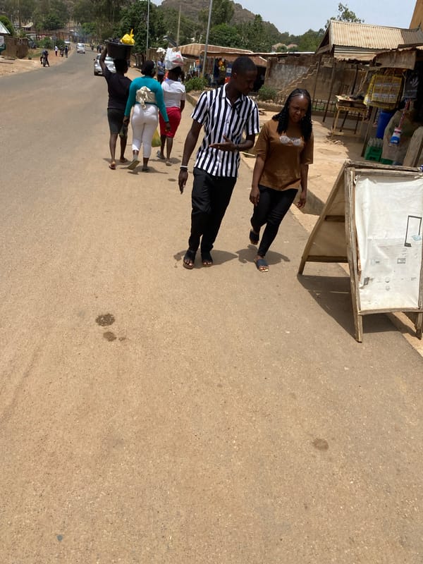 Daily life unfolds on sunny Jos streets
