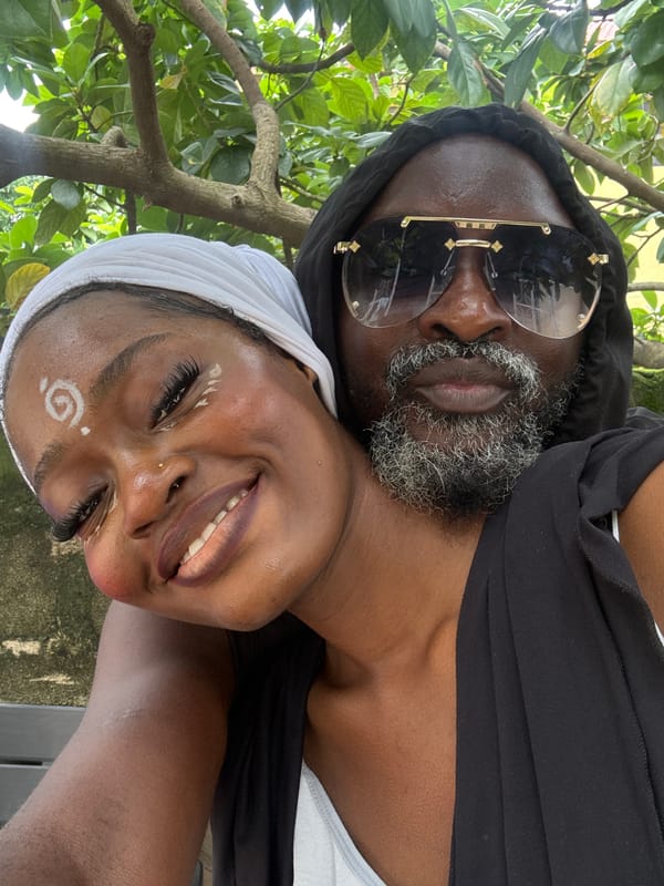 Women pose outdoors in Ado, Nigeria with traditional face paint