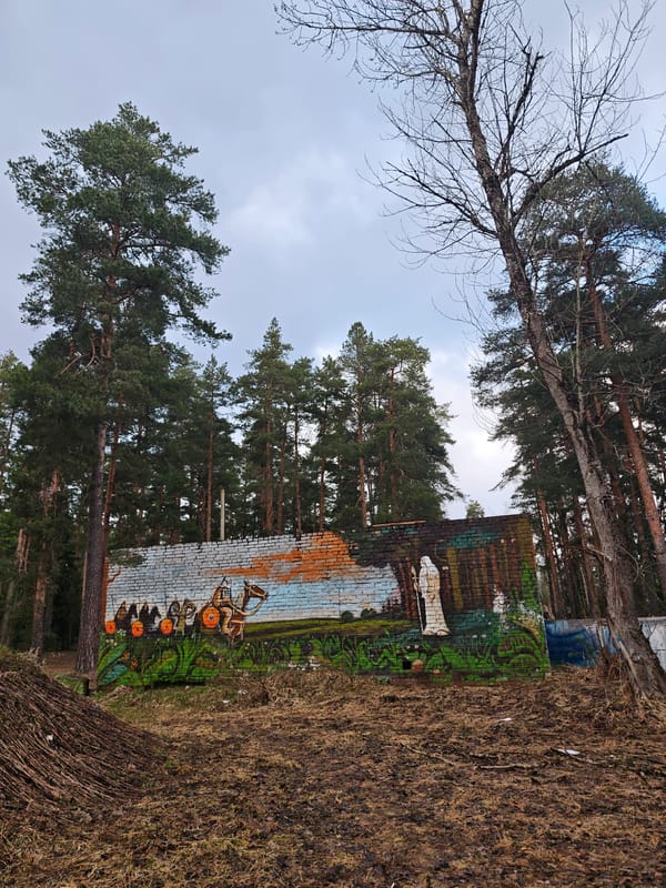 Weathered medieval mural spotted on brick wall in Dubna woods