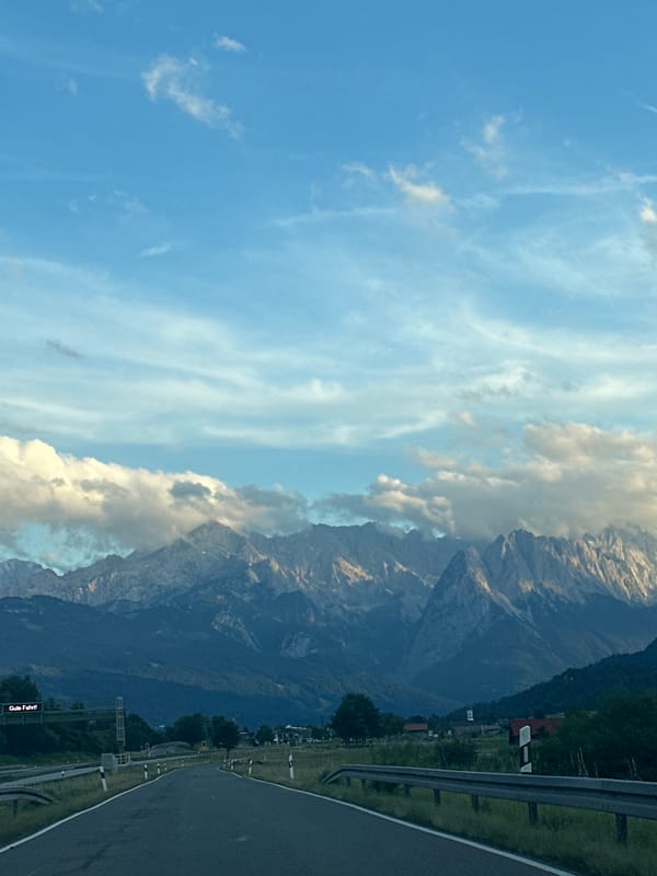 Winding road leads into the cloud-draped Bavarian Alps