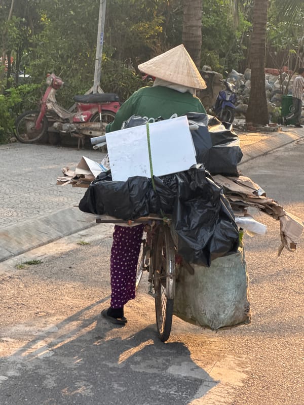 Person with loaded bicycle observed in Đà Nẵng street
