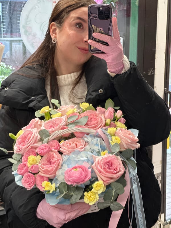 Person takes selfie with basket of roses in Liepaja