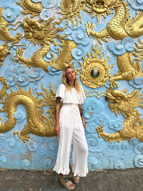 Woman photographs at ancient temple ruins in Mũi Né