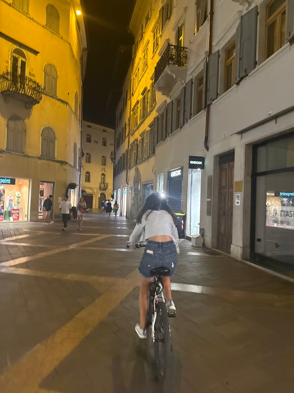 Evening bike ride through Trento's lit-up historic center