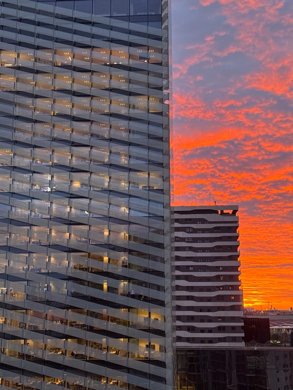 Dramatic sunrise illuminates Barcelona metro skyline with geometric architecture